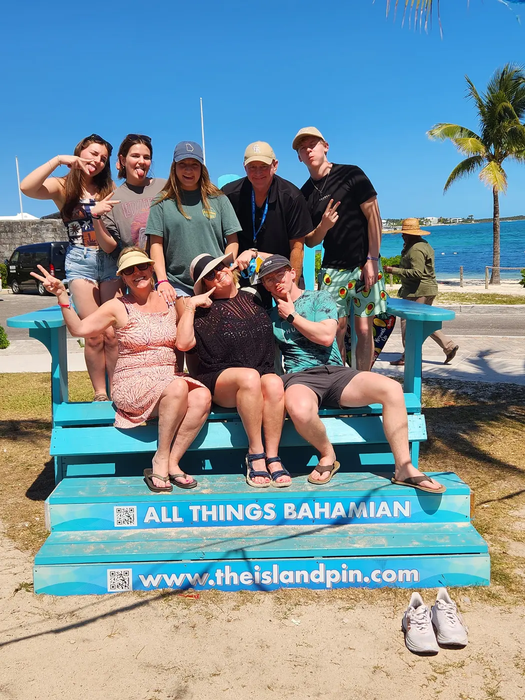 A group on the “All Things Bahamian” bench by the sea