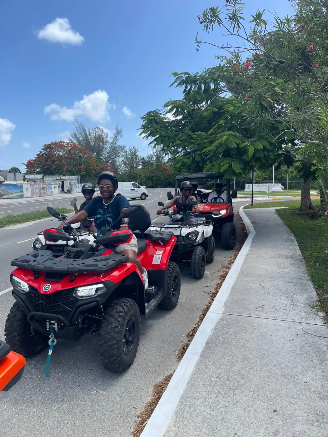 A convoy of red ATVs