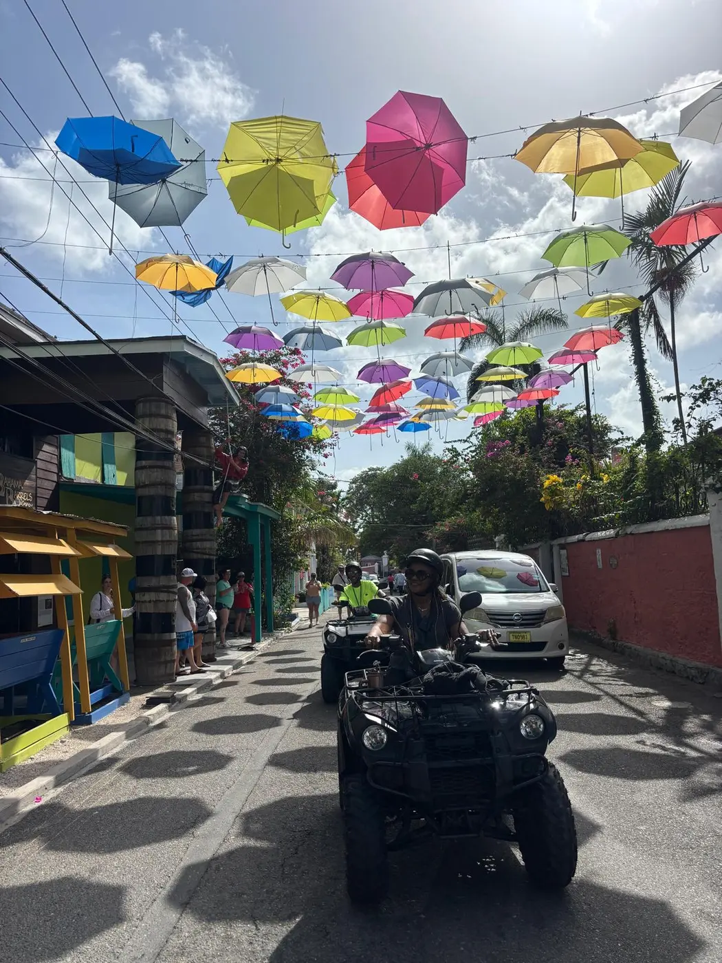 An ATV under a street of colourful umbrellas