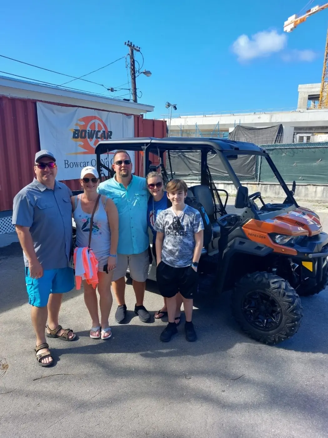 A family beside their buggy at the base