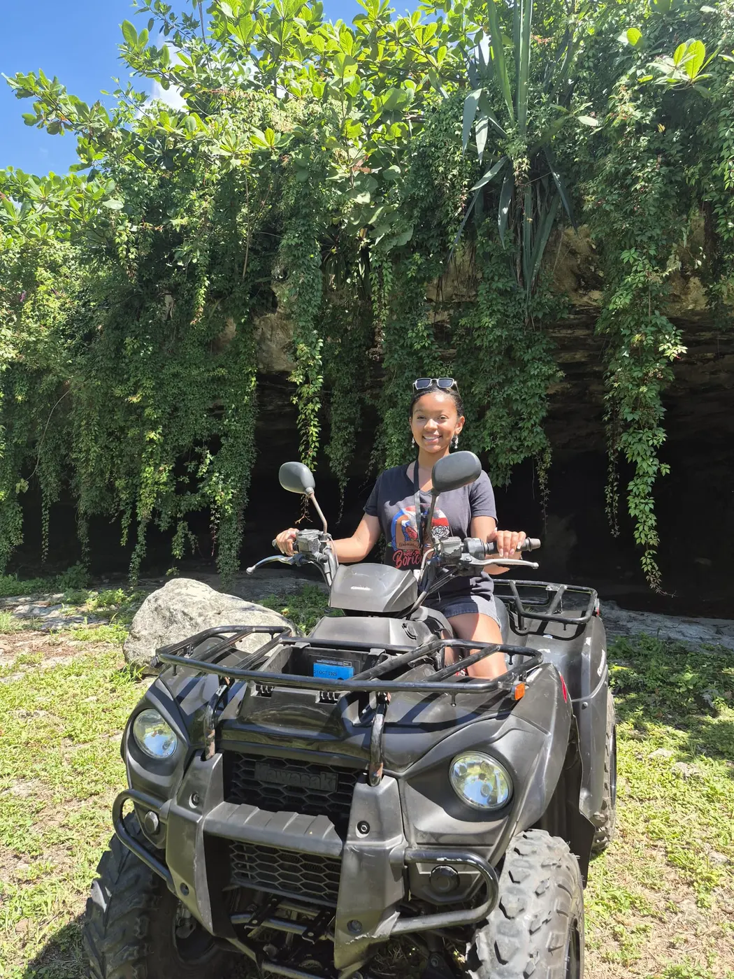 A rider on an ATV under the trees