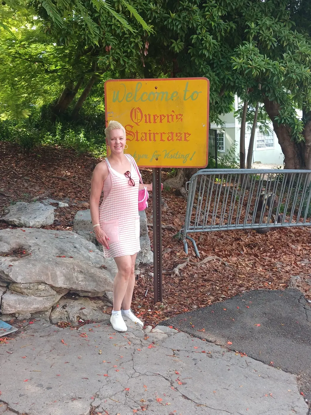 A guest at the Queen’s Staircase sign