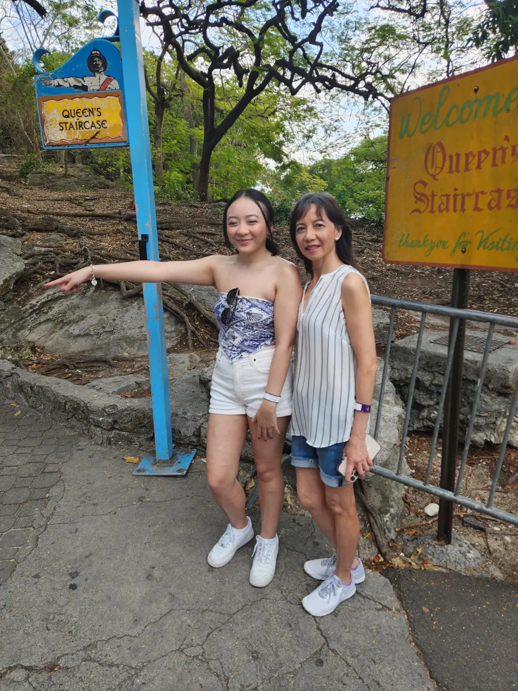 Two guests posing by a sign
