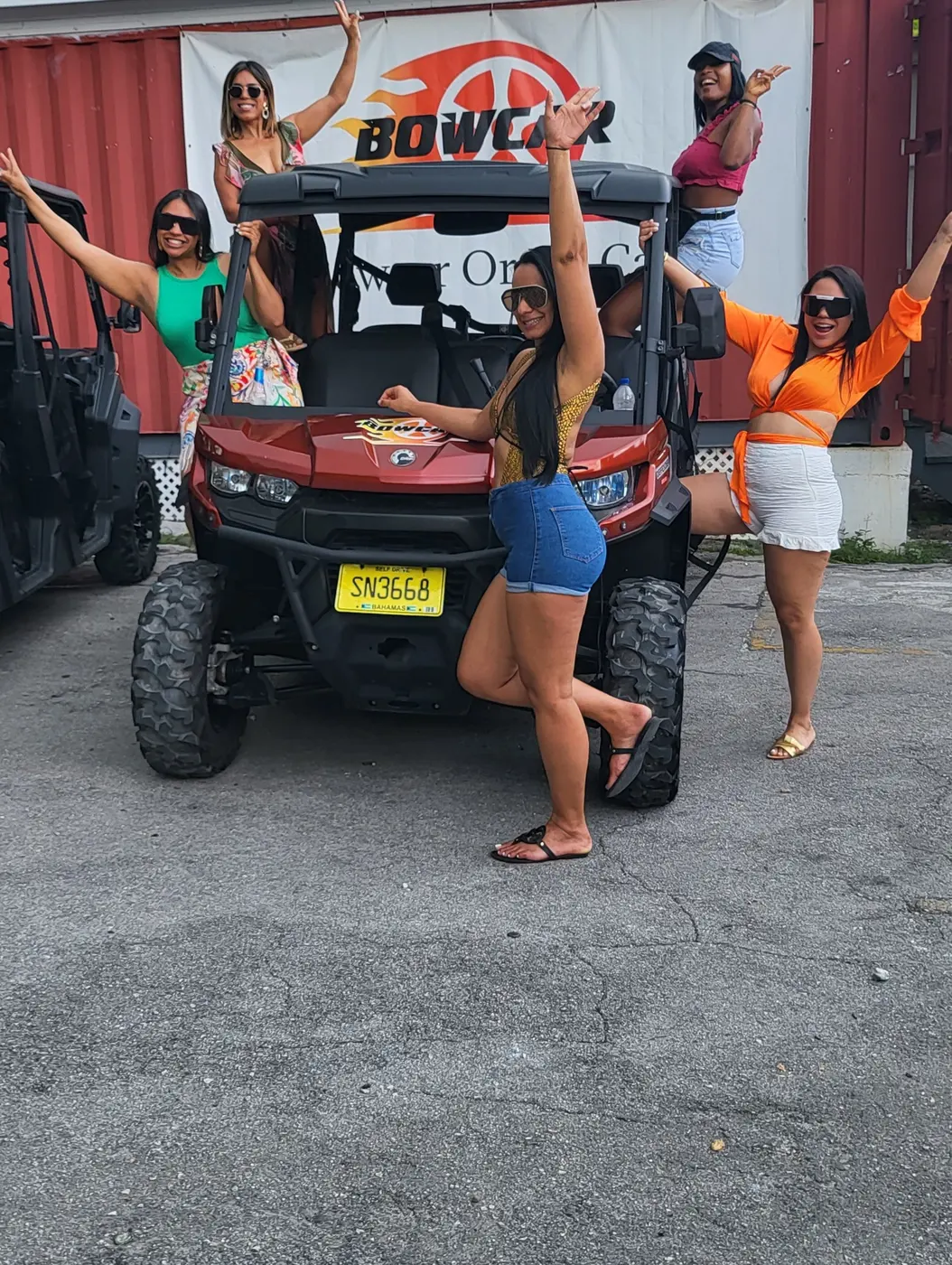 Guests posing with a red buggy at the Bowcar base