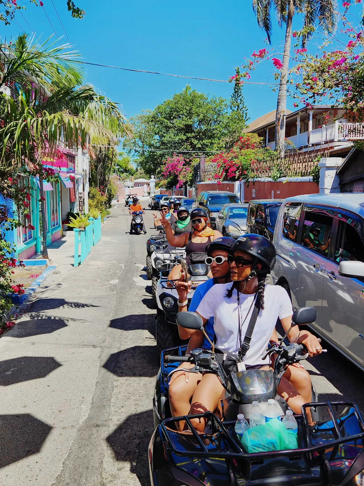 An ATV convoy on a narrow downtown street