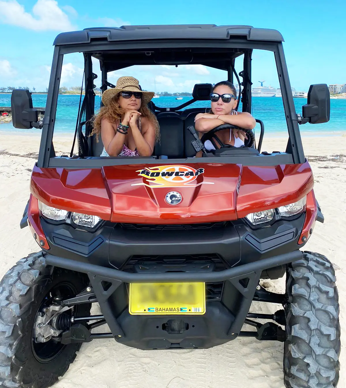 A couple in an orange buggy on the beach