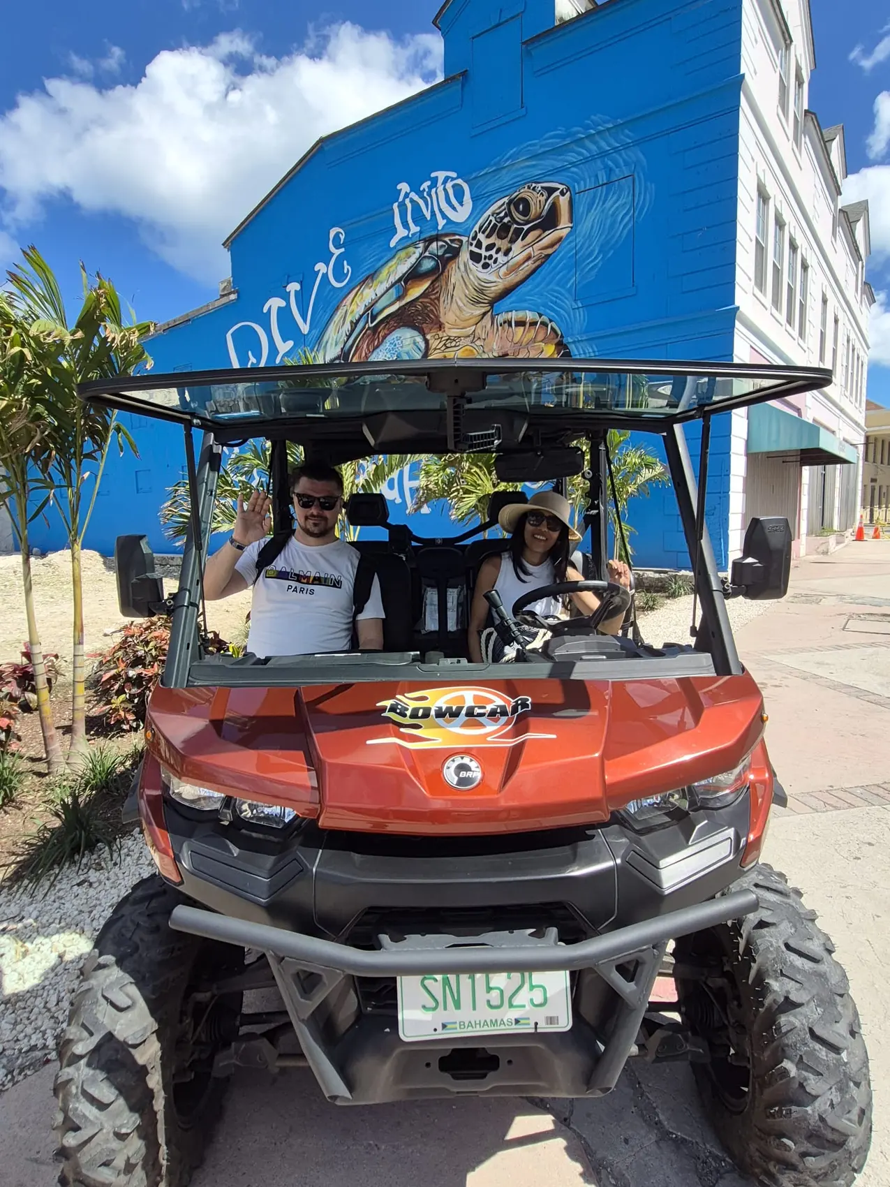 A family in an orange 6-seater buggy
