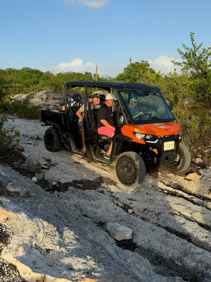 An orange buggy on rocky off-road ground