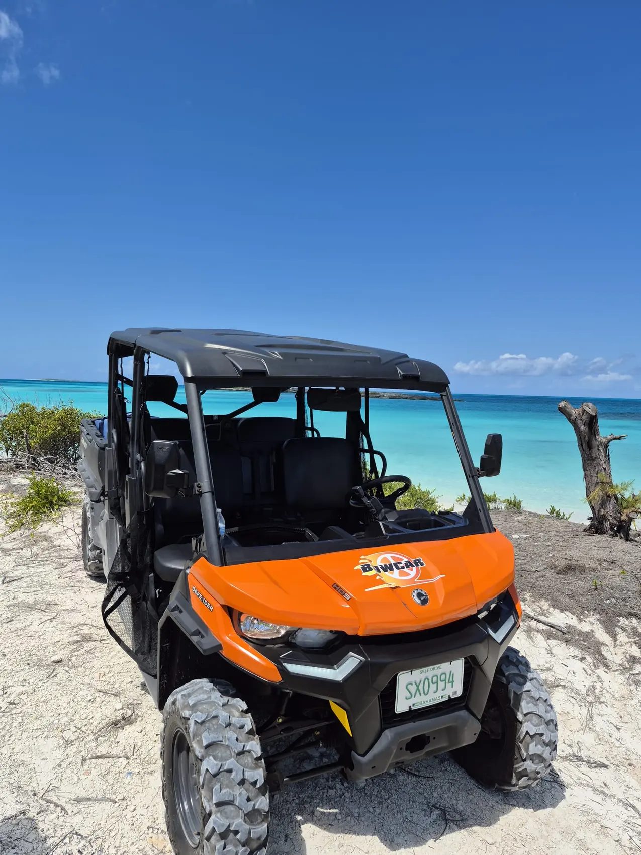 An orange buggy on a beach in Exuma