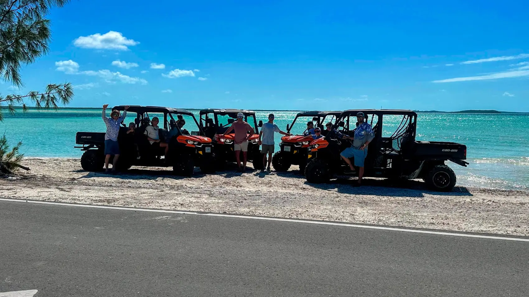 A row of Bowcar buggies beside turquoise water in Exuma