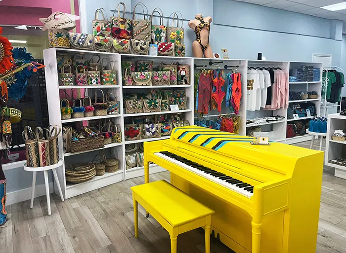 Inside Down Home Collective, with a bright yellow piano