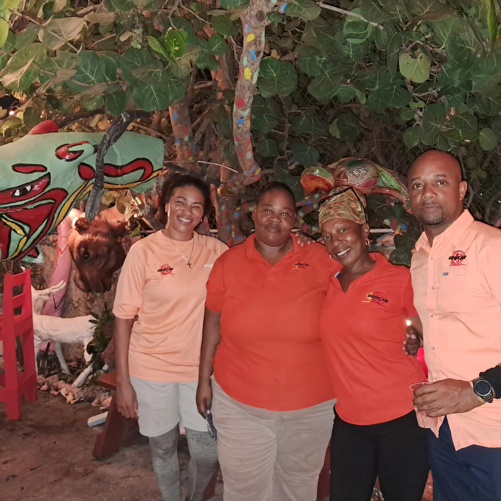 Four Bowcar team members in orange Bowcar shirts